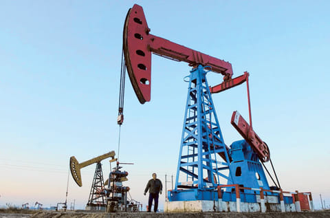 Running idle - China's appetite for oil has plunged, setting off alarm bells in oil producing countries. An emergency meeting of Opec and other suppliers could be called. File picture showing a worker under an oil well at China's Shengli oil field. 