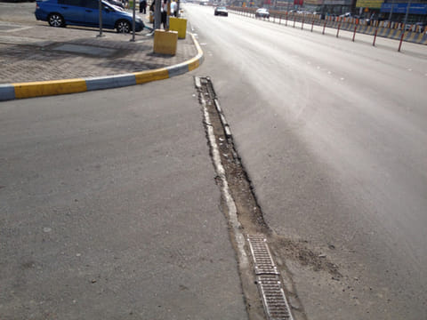 Damaged roads  and exposed metal pose danger to vehicles