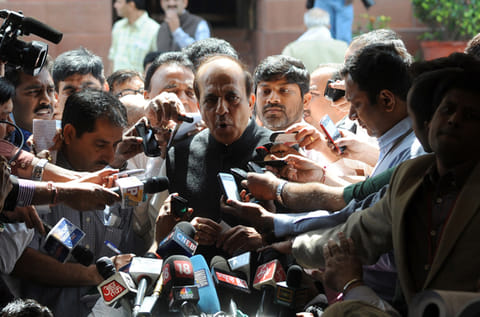 Dinesh Trivedi (centre) addresses media representatives as he leaves Parliament in New Delhi 