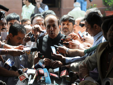 Dinesh Trivedi (centre) addresses media representatives as he leaves Parliament in New Delhi 