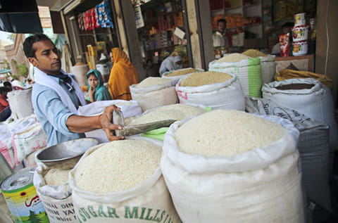 A vendor scoops a measure of rice from a bag at a market in the district of Faisalabad in Punjab, Pakistan. Pakistan’s economic growth is projected to shrink to 2.6 per cent in 2020 from 3.3 per cent in 2019 according to Asian Development Bank.