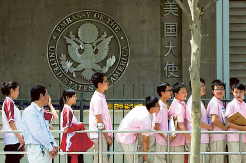 Illustrative image only: In this file photo, Chinese students wait outside the U.S. Embassy for their visa application interviews in Beijing, China, Wednesday, May 2, 2012.  