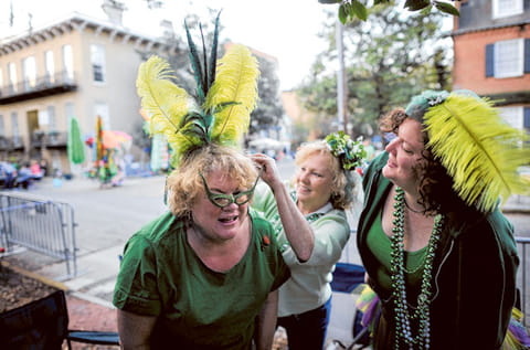File photo: Bev Kehayes, left, of Greensboro, N.C., gets her homemade hat pinned on her head by her friend Mary Parrish, center, and Sara Farnsworth, right, before Savannahs 189-year-old St. Patricks Day parade, Saturday, March 16, 2013, in Savannah, Ga. St. Patrick's Day falls on March 17, which is Sunday. But a number of cities, including Savannah, New York and Chicago are all holding parades Saturday to take advantage of the full weekend. 