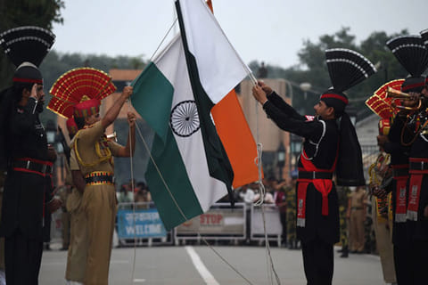 Pakistani Rangers (in black) and Indian Border Security Force (BSF) soldiers (in khaki) perform the flag-lowering ceremony at the Pakistan-India border crossing at Wagah. 