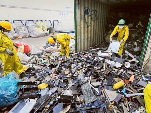 Workers sort through electronic waste. The amount of e-waste generated globally last year represents more than 6.8 kilograms for every living person, according to the UN.