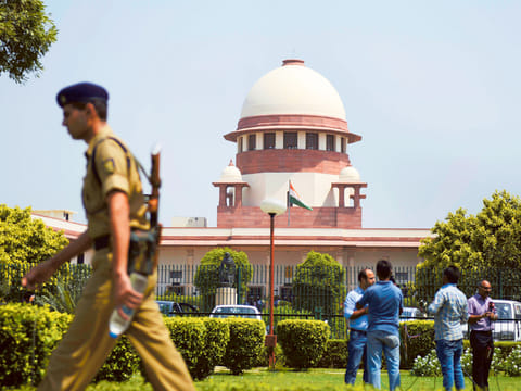 A security personel walks in front of the Indian Supreme court in New Delhi on August 27, 2014.
India’s top court said lawmakers with criminal backgrounds should not serve in government,