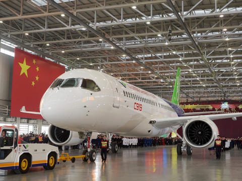 The first C919 passenger jet made by the Commercial Aircraft Corp of China being pulled out during a news conference next to a Chinese national flag at the company's factory in Shanghai on Monday.