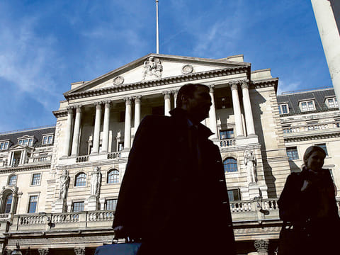 
Pedestrians walk past the Bank of England in London.