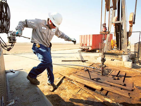 A wireline operator for Canary LLC works on a slick line ata pump jack site near Bakersfield, California. A push by President Donald Trump and the world’s biggest oil producers to shore up crude prices has failed to stop an avalanche of bankruptcies in the industry, and more are still to come.