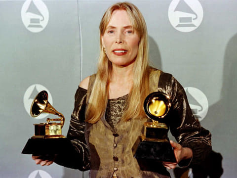 Joni Mitchell holding two Grammy Awards for Best Pop Album, "Turbulent Indigo,"  during the 38th Annual Grammy Awards  in Los Angeles on February 28, 1996.