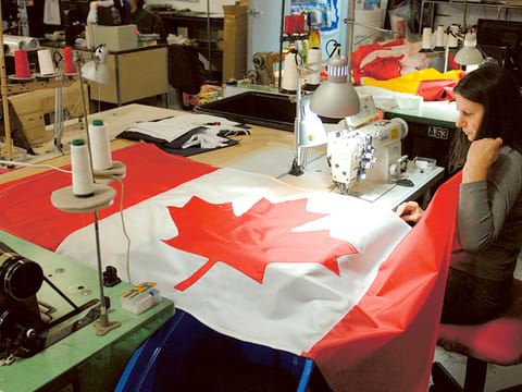 A woman makes a Canadian flag 
