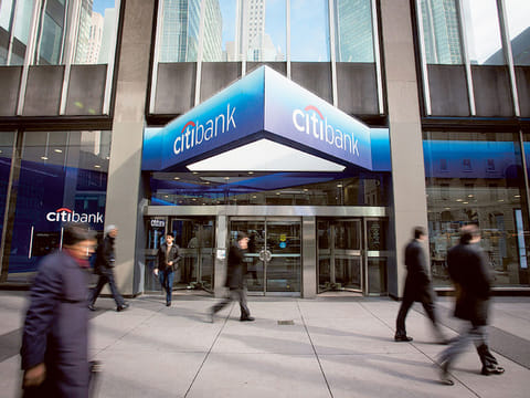 Pedestrians walk past a Citibank branch located adjacent to Citigroup Inc. headquarters in New York. US consumers increased their borrowing in September, helped by the first gain in the category that covers credit cards in seven months.