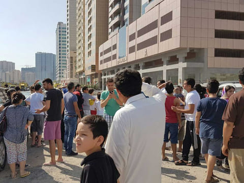 Residents outside a building on fire in Sharjah. (For illustrative purposes only.)