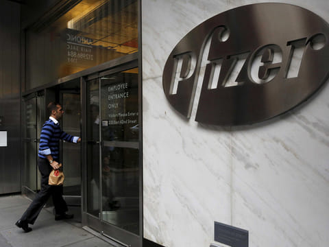 A man enters the employee entrance of the Pfizer World Headquarters building in the Manhattan borough of New York, U.S., November 23, 2015.   