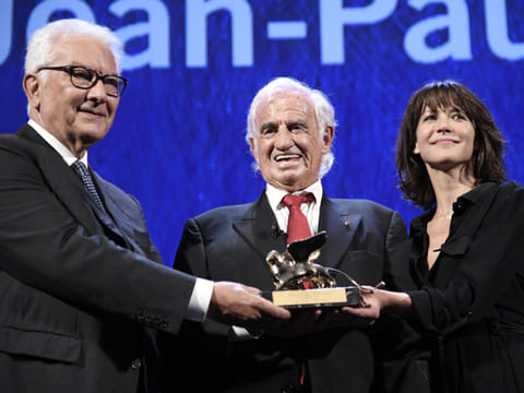 File photo: French actor Jean-Paul Belmondo, centre, holds his Golden Lion for Lifetime Achievement award, next to Biennale President Paolo Baratta, left, and actress Sophie Marceau, during the 73rd annual Venice International Film Festival, in Venice, Italy, Thursday, September 8, 2016. 