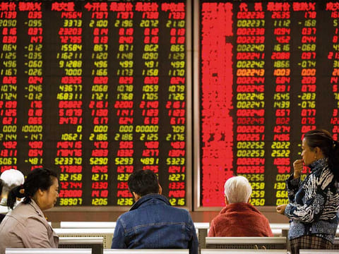 A brokerage house in Beijing. China’s fragile economic recovery is ushering in a dangerous new phase for the nation’s $4.1 trillion corporate bond market.