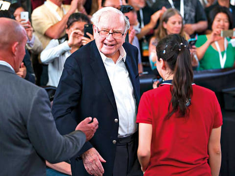 Buffett watches attendees play table tennis at an event on the sidelines the Berkshire Hathaway annual shareholders meeting in Omaha, Nebraska. He assured shareholders on Saturday that his Berkshire Hathaway empire is ready for him and his longtime partner Charlie Munger, 96, to go. But he did not name a successor.