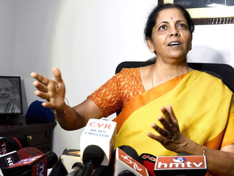 Indian Finance Minister Nirmala Sitharaman, seated right, signs the Indian federal budget after giving final touches, as Indian junior Finance Minister Anurag Thakur, seated left, watches along with finance budget team at her office in New Delhi, on Thursday, July 4, 2019.  