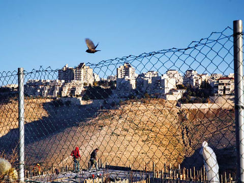 File picture: Palestinian laborers work at a construction site in a new housing project in the Israeli colony of Maale Adumim, near occupied Jerusalem. 