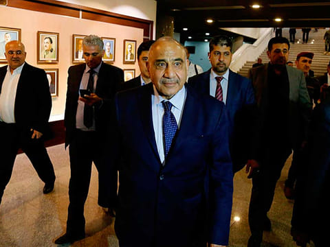 Iraq's new Prime Minister Adel Abdul-Mahdi, center, leaves the parliament building in Baghdad.