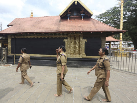 Police woman, above the age of 50, who have been deployed for security circumambulate the main shrine at the Sabarimala temple, one of the world's largest Hindu pilgrimage sites, in the southern Indian state of Kerala, Monday, Nov. 5, 2018.