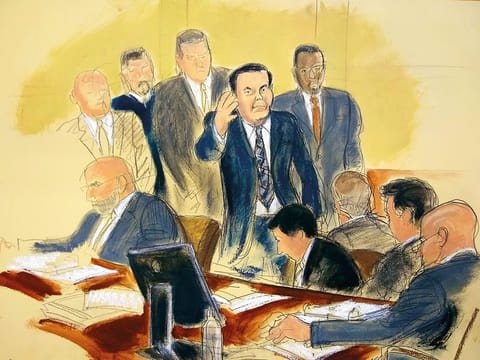 Joaquin "El Chapo" Guzman, surrounded by US Marshals, waves to his wife as he enters the courtroom at Brooklyn Federal Court, as his high-security trial got underway in the Brooklyn borough of New York, Tuesday, Nov. 13, 2018. 