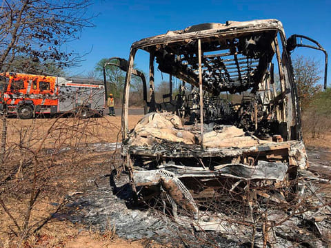 A fire engine is parked near to a burnt out bus in Gwanda about 550 kilometres south of the capital Harare. 