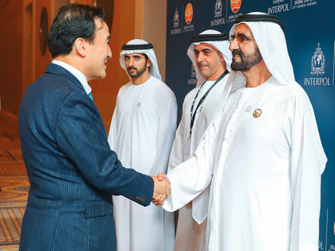 Shaikh Mohammad meets Kim Jong-yang, Interpol’s senior vicepresident, as Shaikh Hamdan and Shaikh Saif look on in Dubai on Sunday. 