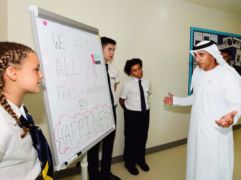 Dr Abdullah Al Karam interacts with Safa Community School students during the well-being census event yesterday.