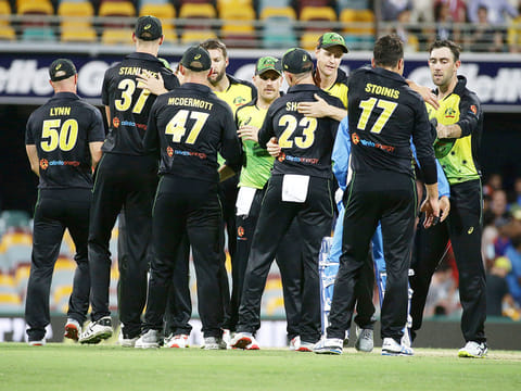 Australia players celebrate after winning the first T20 International cricket match against India in Brisbane, Australia, Wednesday, November 21, 2018. 