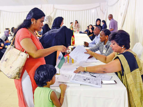 An amnesty seeker with an official from Indian Consulate, at the Al Aweer Federal Authority for Identity and Citizenship, General Directorate of Residency and Foreigners affairs, Dubai.