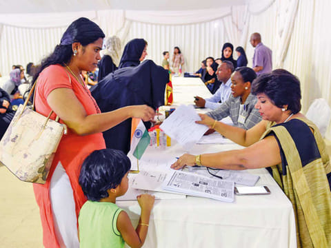 An amnesty seeker with an official from Indian Consulate, at the Al Aweer Federal Authority for Identity and Citizenship, General Directorate of Residency and Foreigners affairs, Dubai.