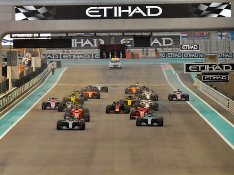 Lewis Hamilton leads the pack at the start of Formula 1 Abu Dhabi Grand Prix at the Yas Marina circuit. 