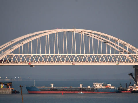 A ship under the the Kerch bridge blocks the passage to the Kerch Strait near Kerch, Crimea, Sunday, Nov. 25, 2018. 