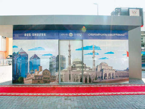 The bus shelters are equipped with electronic bulletin board displays showing bus service timetables and routes.