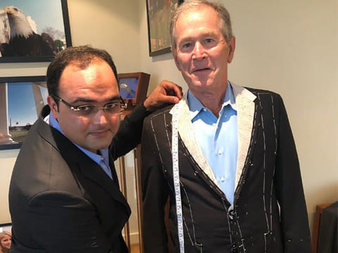 Sarfraz Akbar, who runs a tailoring shop in Karachi, was spotted with the former US president.