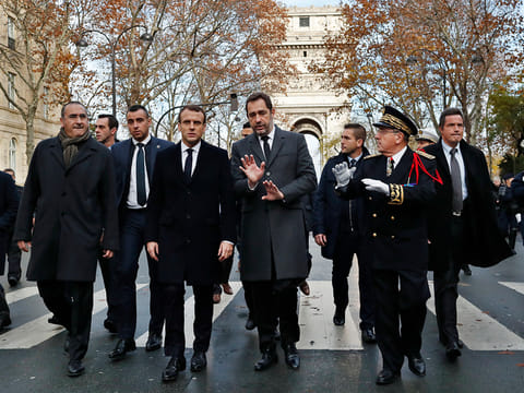 France's President Emmanuel Macron, centre left, Interior Minister Christophe Castaner, centre, Secretary of State to the Interior Minister Laurent Nunez, left, and police Prefect Michel Delpuech, right, arrive to visit firefighters and riot police officers the day after a demonstration, in Paris, Sunday, Dec. 2, 2018. 