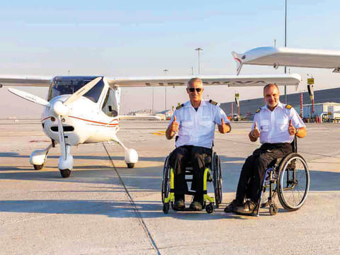 Pilots Mike Lomberg (left) and Guillaume Feral celebrate their arrival from Saudi Arabia, at Dubai World Central. 
