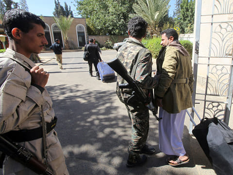 A relative of a Houthi delegation member participating in the negotiations in Sweden carries a bag at Sanaa airport, Yemen.