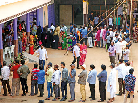 Indians stand in a queue to cast their votes in Hyderabad, India, Friday, December 7, 2018.