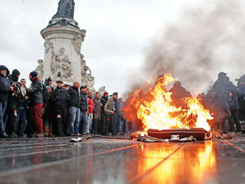 A bin burns during a protest in Paris. France was bracing for fresh violence, following chaos in Paris last weekend, with thousands of protesters railing against rising prices.