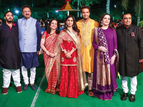 RIL chief Mukesh Ambani, wife Nita Ambani, son Anant Ambani with daughter Isha Ambani, fiance Anand Piramal, and in-laws, Ajay and Swati Piramal.
