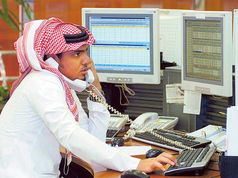 A Saudi employee at work inside the traders room at the Saudi Investment Bank in Riyadh.
