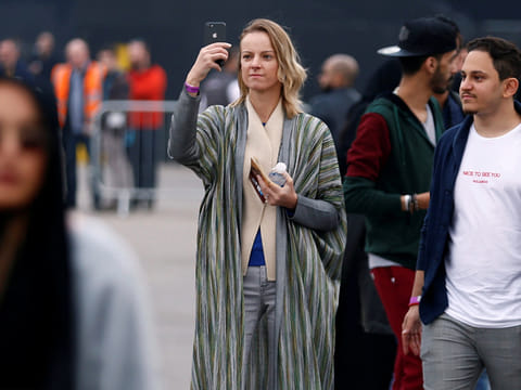 A tourist takes a photo as she attends a Formula E race in Riyadh