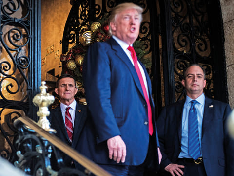 Michael Flynn (left) with US President Donald Trump and the then chief-of-staff Reince Priebus (right) at Mar-a-Lago in Palm Beach, Florida, in December 2016. 