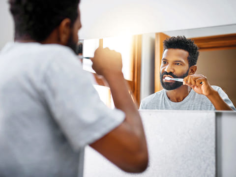 A man brushing his teeth.