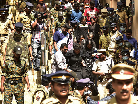 Police escort women activist from a 'Manithi' NGO as they return back after being surrounded by Hindu activist to stop their attempt to reach Sabarimala Ayyapa temple, in Pamba in the southern state of Kerala, on December 23, 2018. 