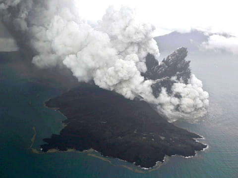 This aerial shot taken on Sunday, Dec. 23, 2018, shows Mount Anak Krakatau as it erupts on Java Strait, Indonesia.