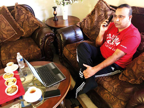 Madhu Bellam, a member of the Overseas Friends of BJP, calls potential voters in Hyderabad, India, from his home in Clarksburg, Maryland, United States.