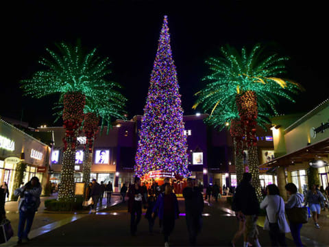 People shop for gifts a week before Christmas at an outlet mall in Commerce, California.